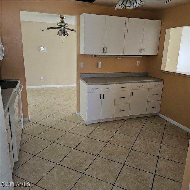 kitchen with white cabinets, light tile patterned floors, white electric range, and ceiling fan