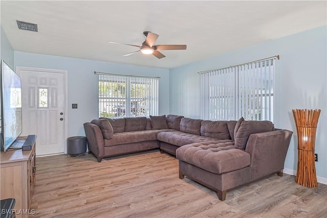 living room featuring ceiling fan and light hardwood / wood-style floors