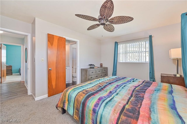 bedroom with connected bathroom, light colored carpet, and ceiling fan