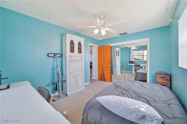 bedroom featuring a closet, ceiling fan, and light colored carpet