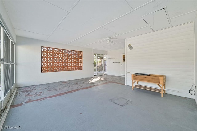 unfurnished sunroom featuring ceiling fan and plenty of natural light