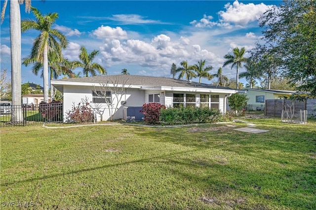 back of property featuring a yard