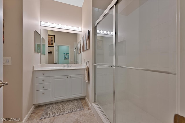 bathroom with a shower with door and vanity