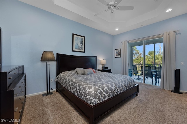 bedroom featuring carpet flooring, ceiling fan, a tray ceiling, and access to exterior