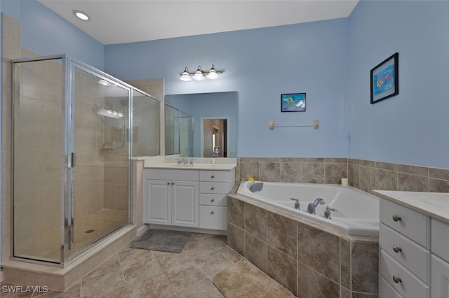 bathroom with separate shower and tub and vanity