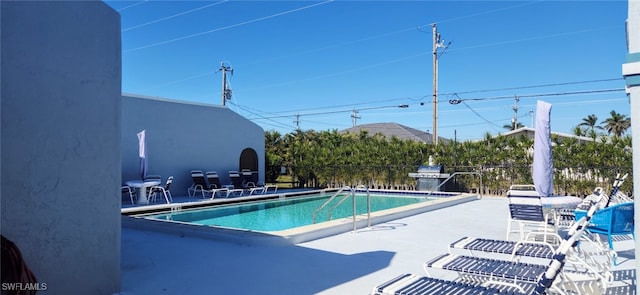 view of pool featuring a grill and a patio