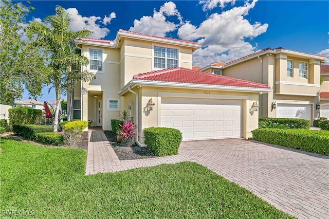 mediterranean / spanish-style house with a front lawn and a garage