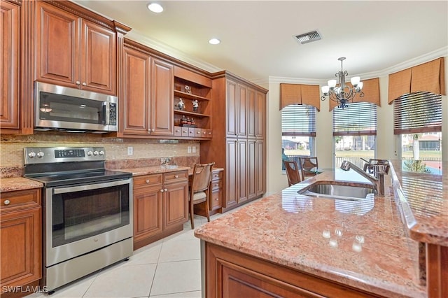 kitchen with stainless steel appliances, sink, light tile patterned flooring, hanging light fixtures, and a notable chandelier