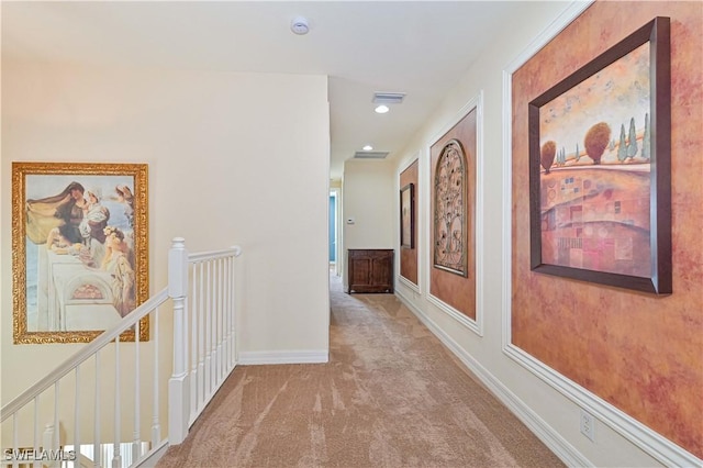 hall featuring light colored carpet