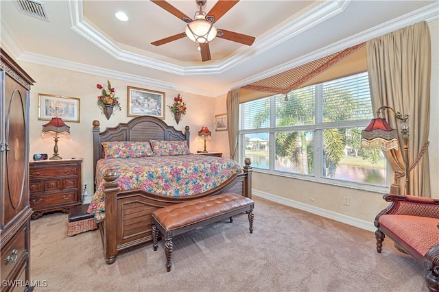 bedroom featuring ceiling fan, light colored carpet, ornamental molding, and a raised ceiling