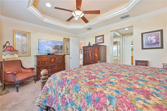 bedroom featuring ornamental molding, ceiling fan, and a tray ceiling