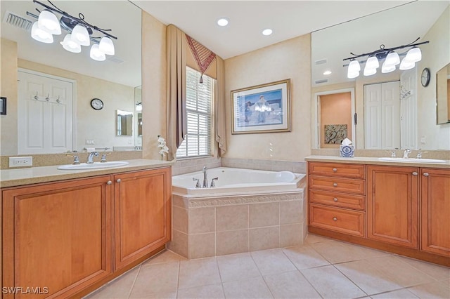 bathroom with vanity, tiled bath, and tile patterned floors