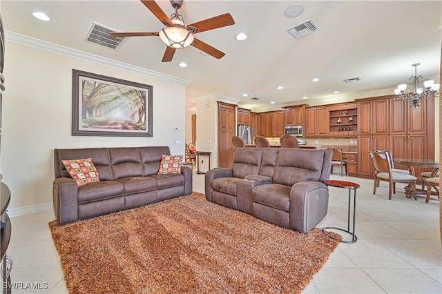 living room with ceiling fan with notable chandelier, ornamental molding, and light tile patterned floors