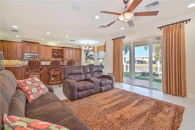 living room featuring ornamental molding, ceiling fan with notable chandelier, and light tile patterned floors