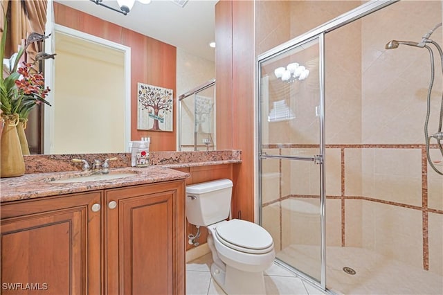 bathroom with tile patterned floors, an enclosed shower, vanity, and toilet