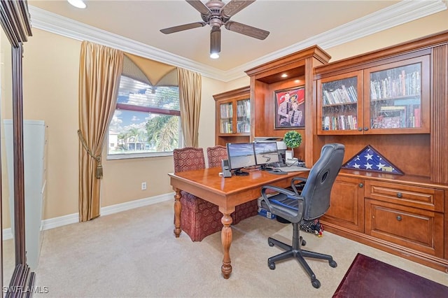 home office featuring ceiling fan, crown molding, and light colored carpet