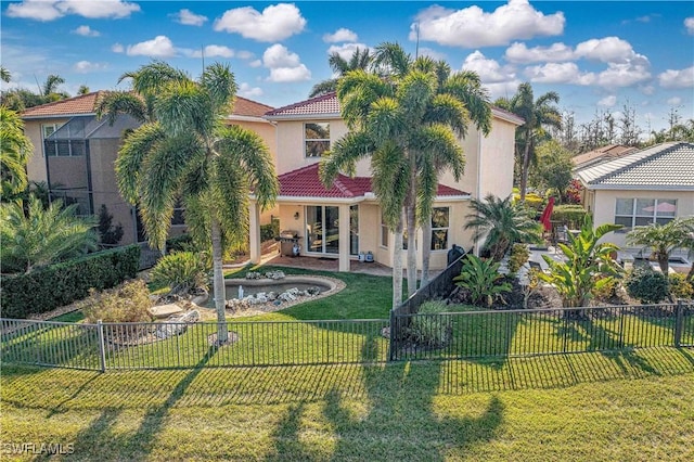 rear view of property featuring a lawn