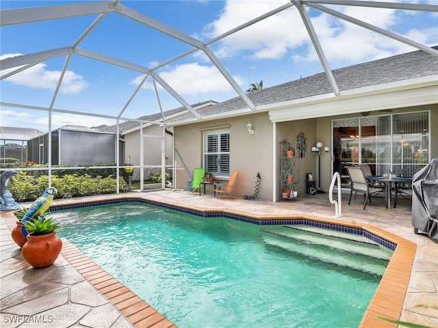 view of swimming pool featuring a patio and a lanai