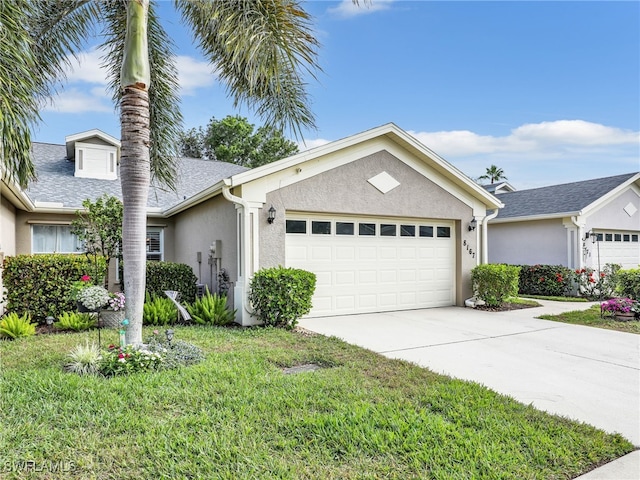 ranch-style house featuring a front yard and a garage