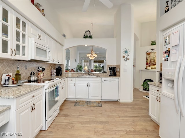 kitchen featuring white cabinets, white appliances, sink, and hanging light fixtures