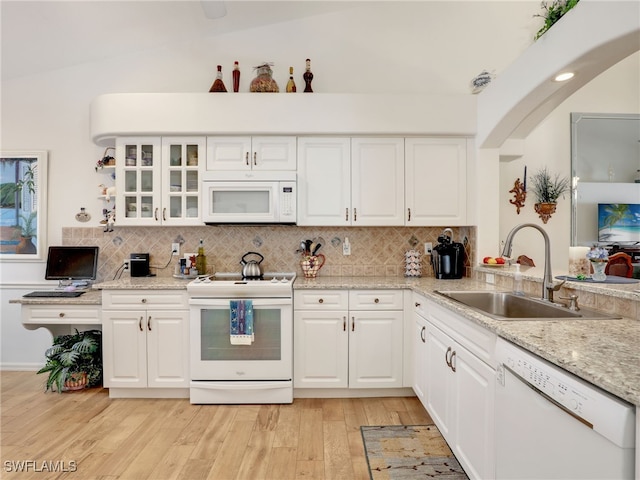 kitchen featuring white cabinets, light stone counters, white appliances, and sink