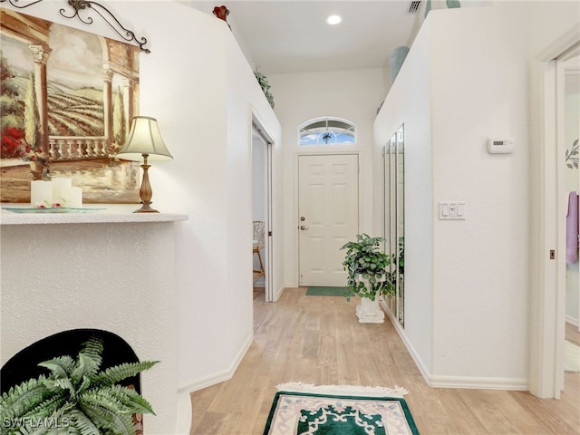 hall with light hardwood / wood-style floors