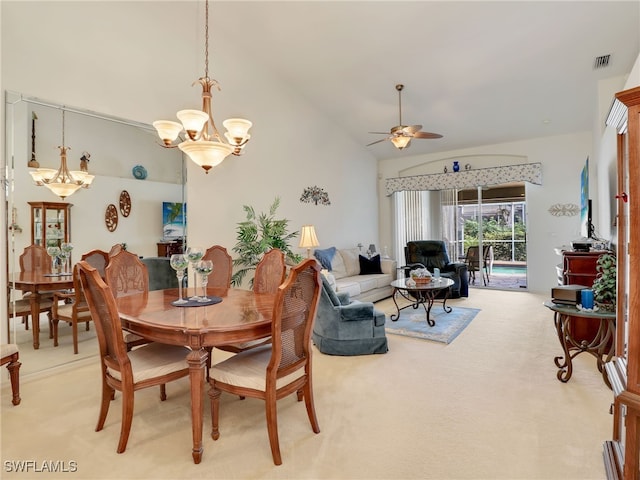 dining room featuring lofted ceiling, carpet floors, and ceiling fan with notable chandelier