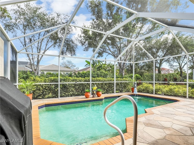 view of pool with a lanai and a patio