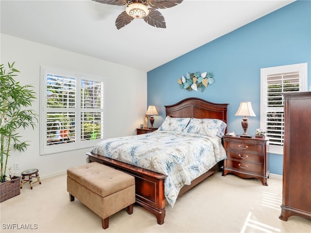 bedroom featuring multiple windows, light carpet, and ceiling fan