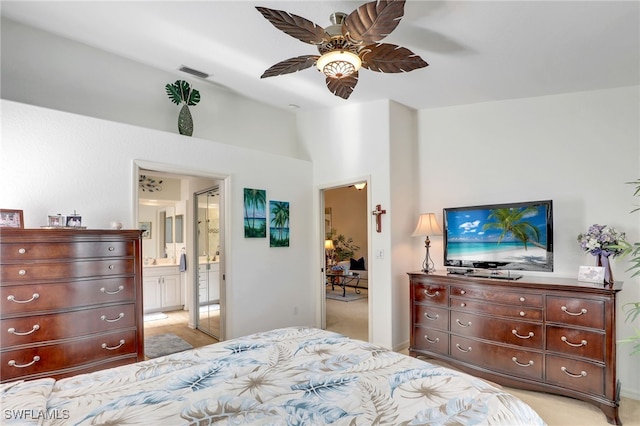 bedroom with ensuite bath and ceiling fan