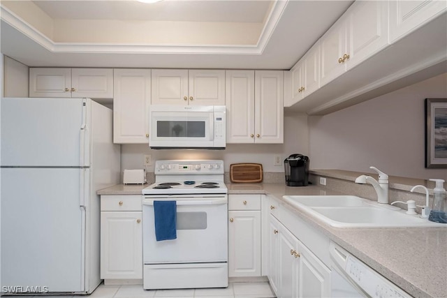 kitchen featuring white cabinetry, white appliances, sink, and a tray ceiling