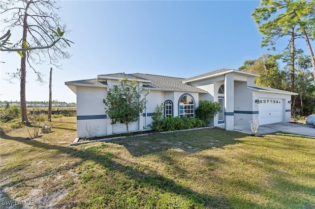 view of front of home with a front lawn and a garage