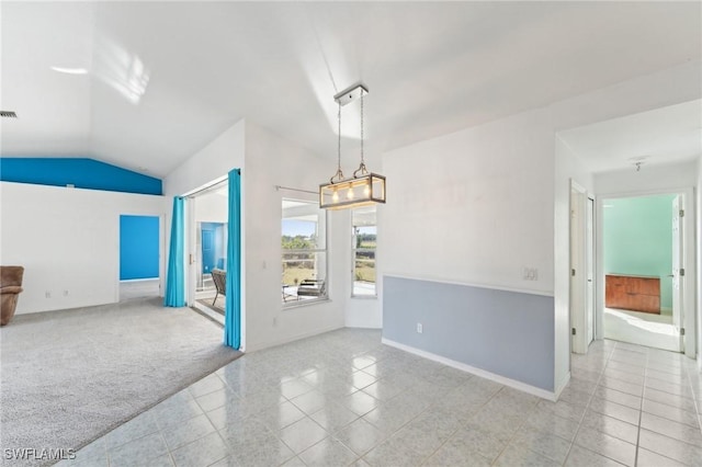 tiled spare room featuring lofted ceiling