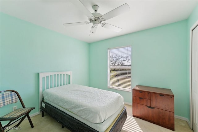 bedroom with light colored carpet and ceiling fan