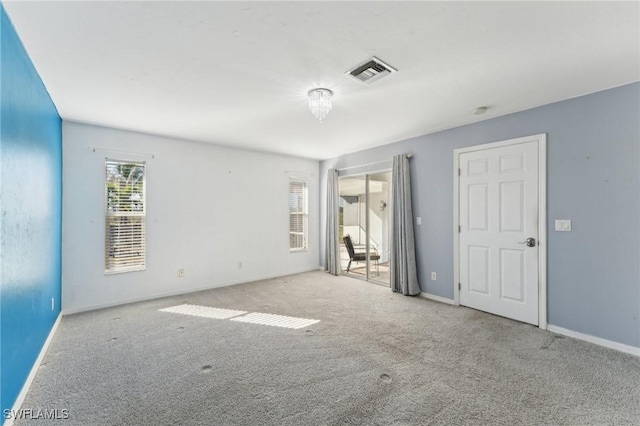 unfurnished room featuring light carpet