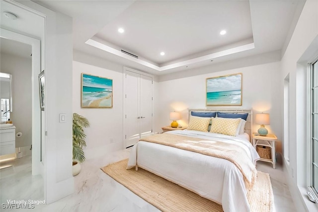 bedroom featuring a raised ceiling