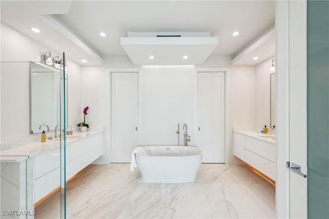 bathroom featuring vanity and a tub