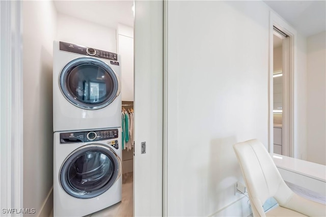 clothes washing area with stacked washer / drying machine