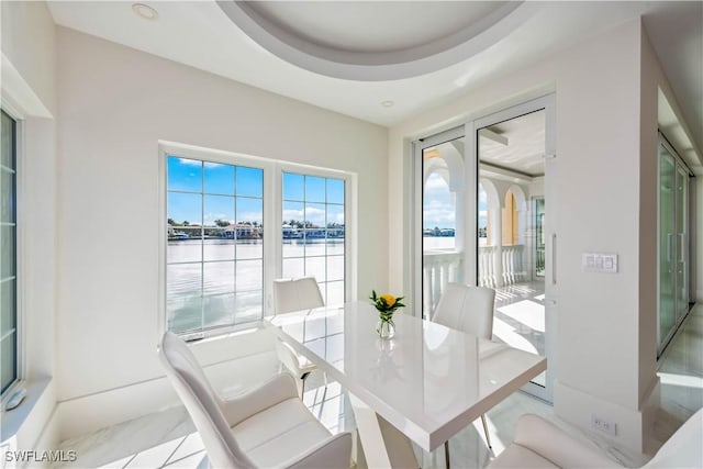 dining area featuring a tray ceiling