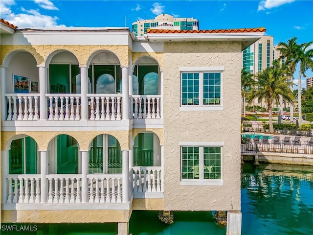 rear view of house featuring a water view