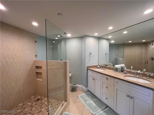 bathroom featuring tile patterned floors, vanity, and walk in shower