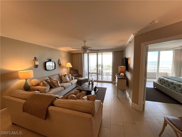 living room with ceiling fan, crown molding, and light tile patterned flooring