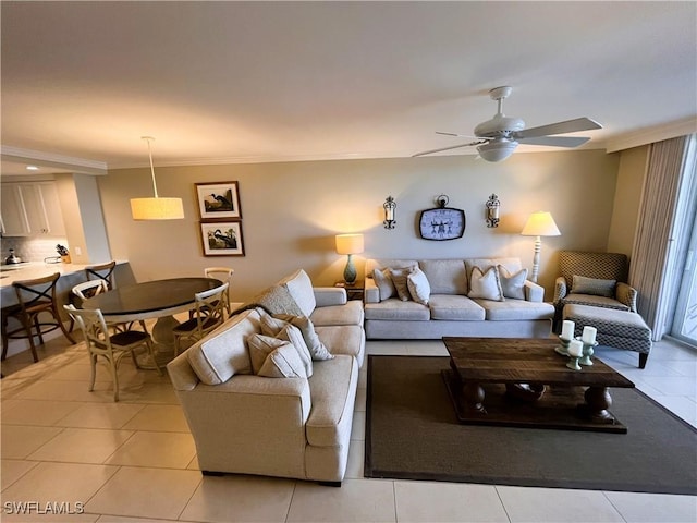 living room featuring light tile patterned flooring, ceiling fan, and ornamental molding