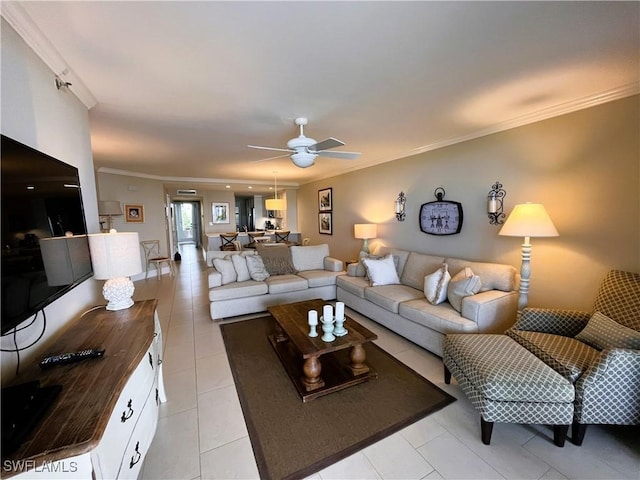 living room featuring ceiling fan, crown molding, and light tile patterned flooring