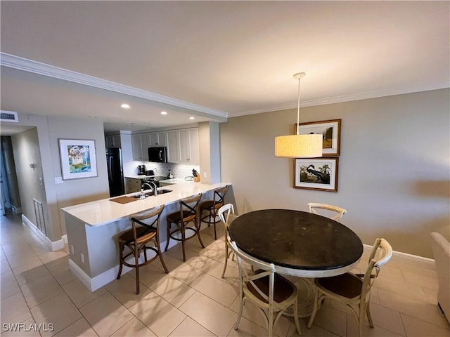 kitchen with kitchen peninsula, gray cabinets, black appliances, and light tile patterned floors