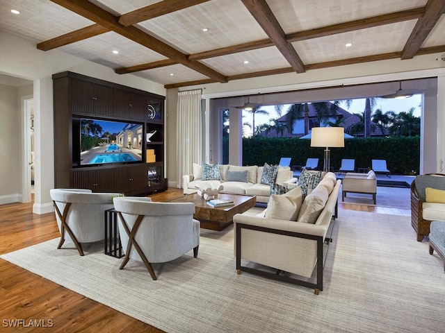 living room featuring light hardwood / wood-style flooring, beamed ceiling, and coffered ceiling