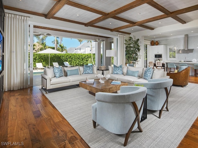 living room with plenty of natural light, beamed ceiling, light hardwood / wood-style floors, and coffered ceiling