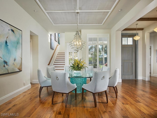 dining space with hardwood / wood-style flooring and an inviting chandelier