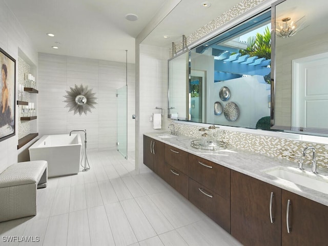 bathroom featuring decorative backsplash, vanity, independent shower and bath, and tile walls