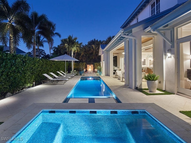 view of pool with a patio and a hot tub